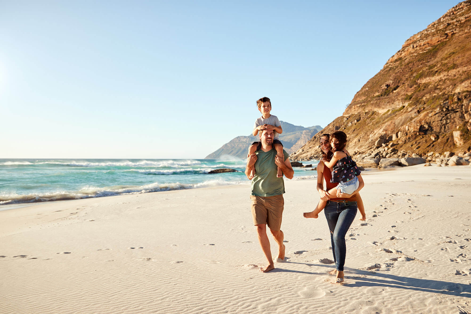 young_family_walking_along_on_a_beach